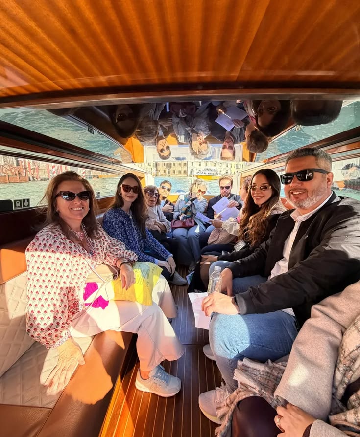 Participants of Decoding Biennale crossing Venice in a wooden water taxi
