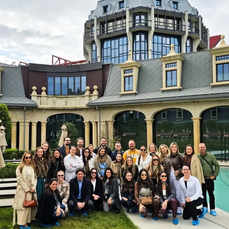 Large group of participants of Inputs from Fuorisalone in a Milanese arched courtyard